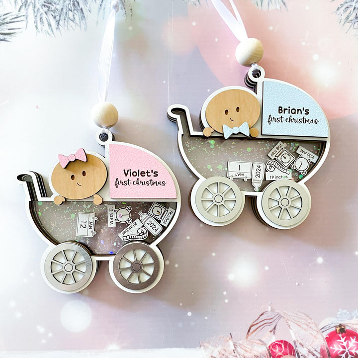 Baby boy and baby girl first Christmas ornament in carriage design, personalized with name and birth details.