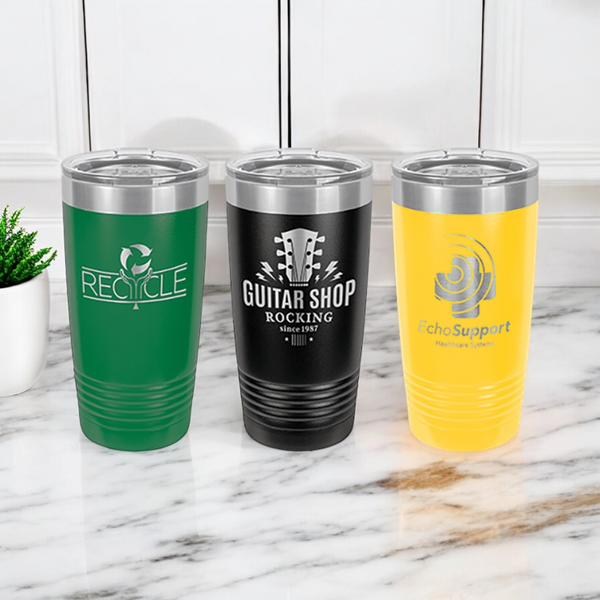 Three 20oz insulated stainless steel tumblers featuring custom logo designs on a marble countertop in green, black and yellow.