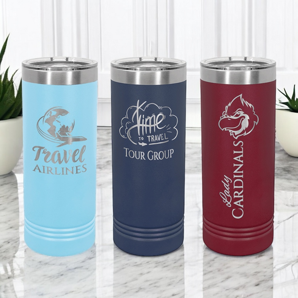 Three custom 22oz skinny tumblers with slider lids displayed on a marble countertop. The tumblers feature custom corporate logos.  Perfect for corporate branding, promotional gifts, or personalized drinkware.