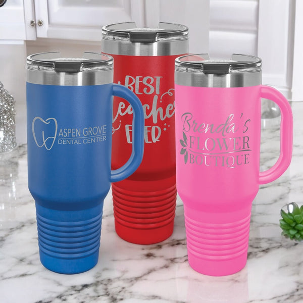 Custom 40oz vacuum insulated stainless steel travel mugs with handles and reusable straws, displayed in blue, red, and pink.  Ideal for corporate branding, promotional gifts, or personalized drinkware, with a slim bottom that fits most standard cup holders.