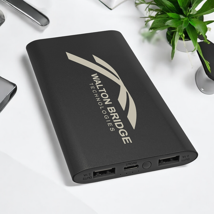 Custom 8000mAh black anodized aluminum wireless power bank with dual USB ports and USB-C cord, featuring custom logo.