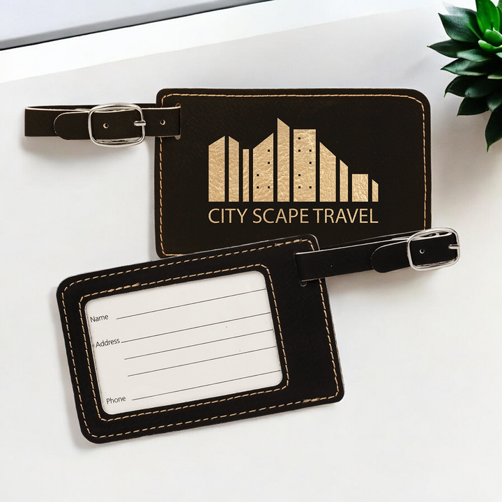 Custom laser-engraved black leatherette luggage tag featuring a silver buckle strap, clear ID window, and lines for Name, Address, and Phone, perfect for corporate branding and travel gifts.