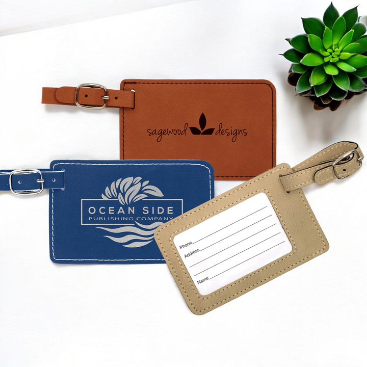 Custom laser-engraved leatherette luggage tags with silver buckle straps and removable inserts for Name, Address, and Phone, ideal for corporate branding and travel gifts."