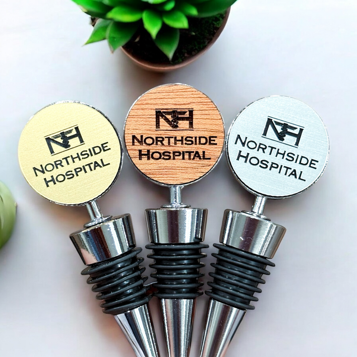 Custom laser engraved wine bottle stoppers in gold, silver, and wood finishes with personalized branding, ideal for corporate gifts, employee appreciation, or special occasions.