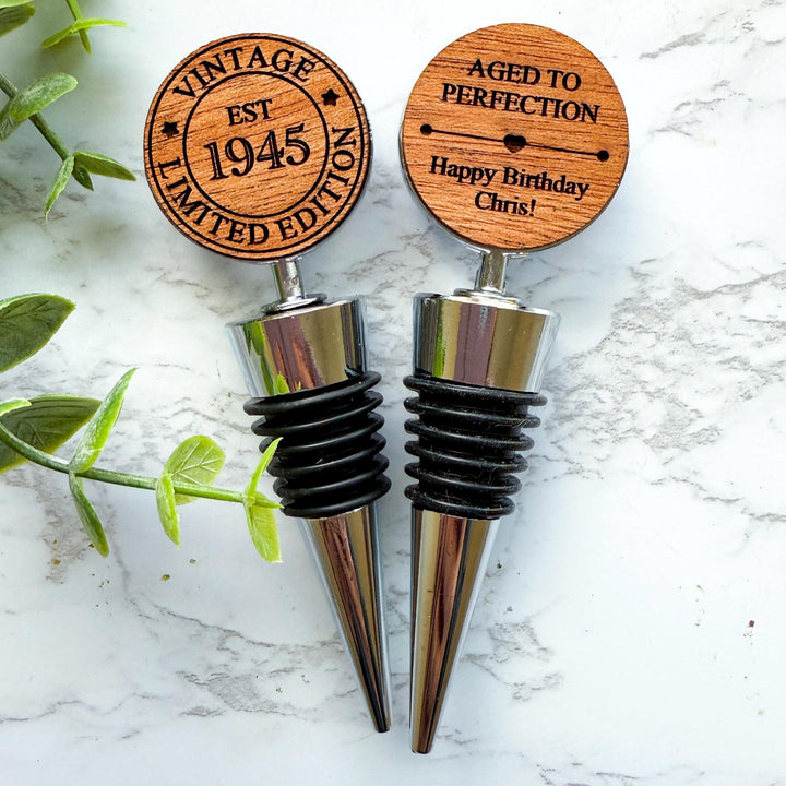 Double sided personalized wooden wine stoppers for a 80th birthday, engraved with &quot;Vintage Limited Edition EST 1945&quot;design.  Ideal for milestone birthday celebrations and wine lovers.