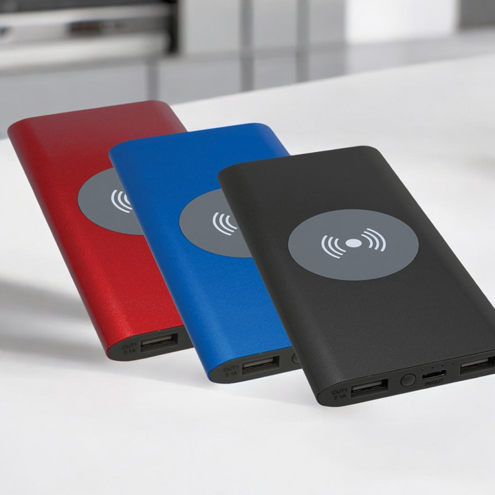 8000mAh wireless power banks in red, blue, and black with dual USB ports, perfect for portable charging and corporate branding.