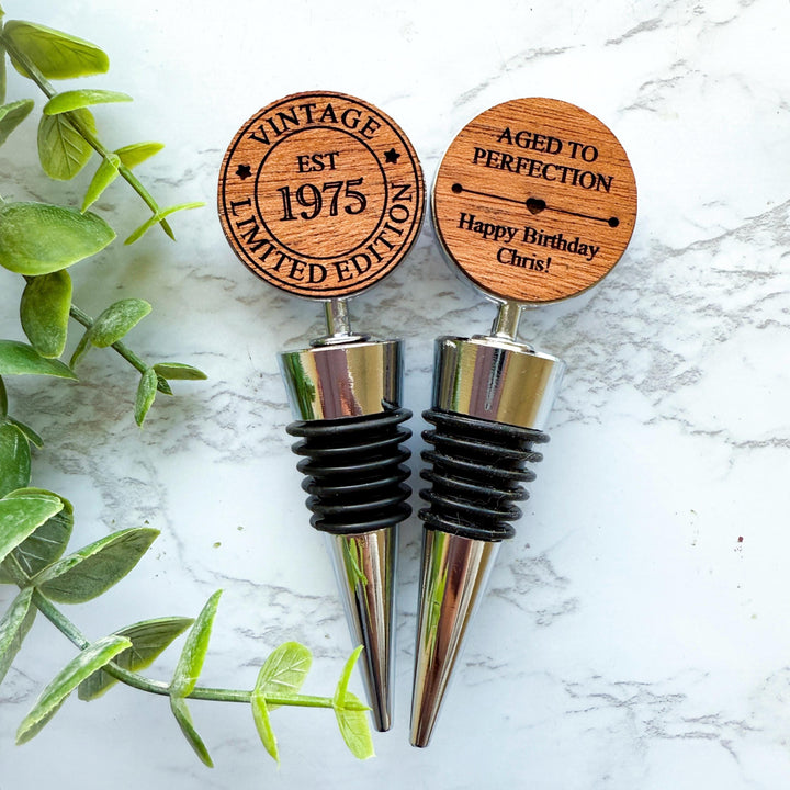 Double sided personalized wooden wine stoppers for a 50th birthday, engraved with &quot;Vintage Limited Edition EST 1975&quot; design.  Ideal for milestone birthday celebrations and wine lovers.