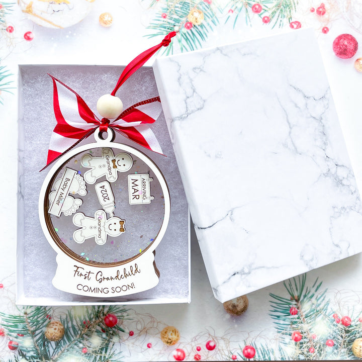 First grandchild Christmas ornament with customizable gingerbread charms for grandparents and pets in a gift box