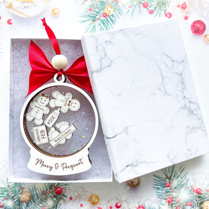 Merry and Pregnant Christmas ornament for pregnancy reveal, featuring custom baby and pet details in a gift box