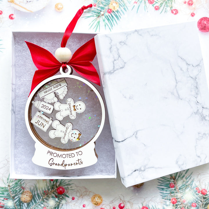 Personalized baby announcement ornament for grandparents, festive Christmas gift revealing pregnancy news in a memorable way.