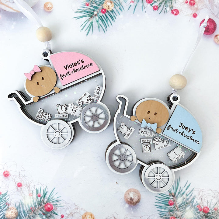 Personalized baby’s first Christmas ornament featuring custom baby carriage design with name and birth stats.