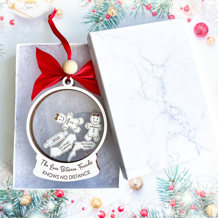 Custom long distance ornament engraved with “The love between friends knows no distance,” perfect holiday gift for best friends living miles apart.