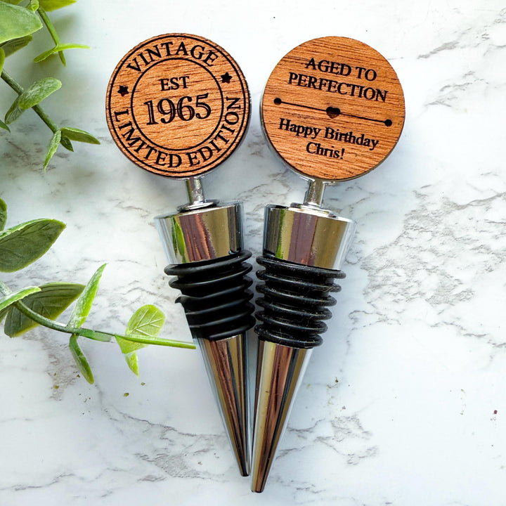 Double sided personalized wooden wine stoppers for a 60th birthday, engraved with &quot;Vintage Limited Edition EST 1965&quot; design.  Ideal for milestone birthday celebrations and wine lovers.